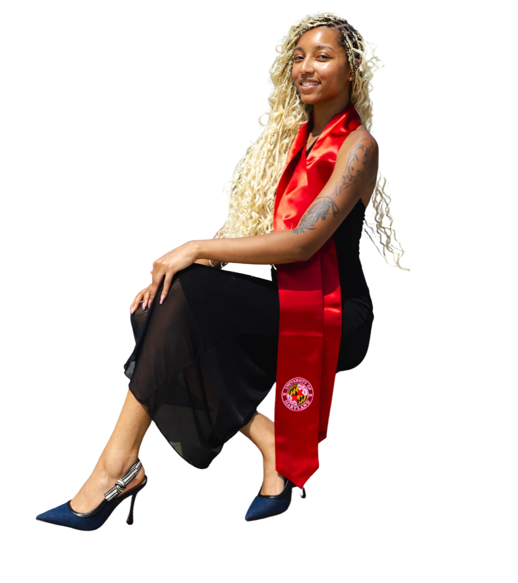 Amaya smiling, seated, in a black dress, red University of Maryland stole and navy heels